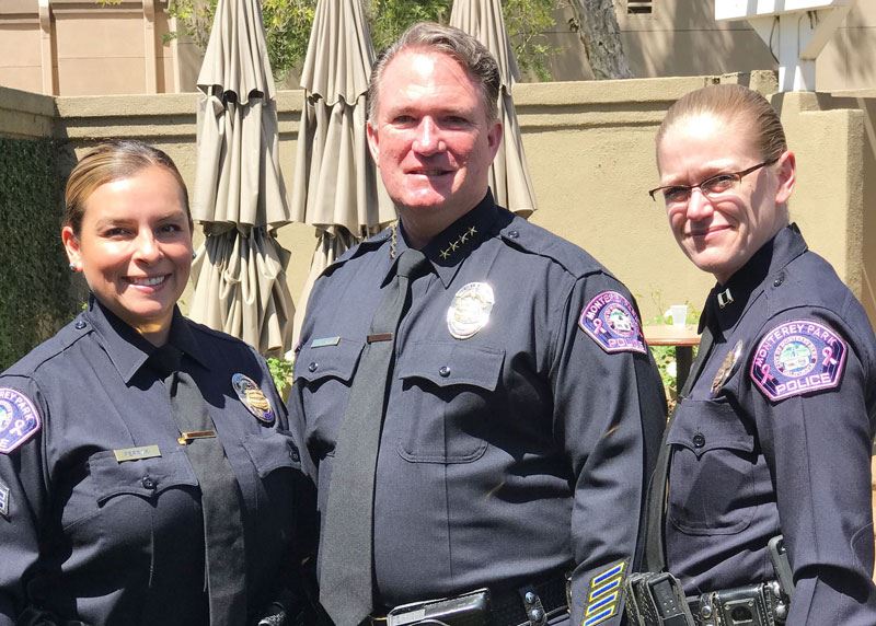 Police department staff in uniform with pink patches